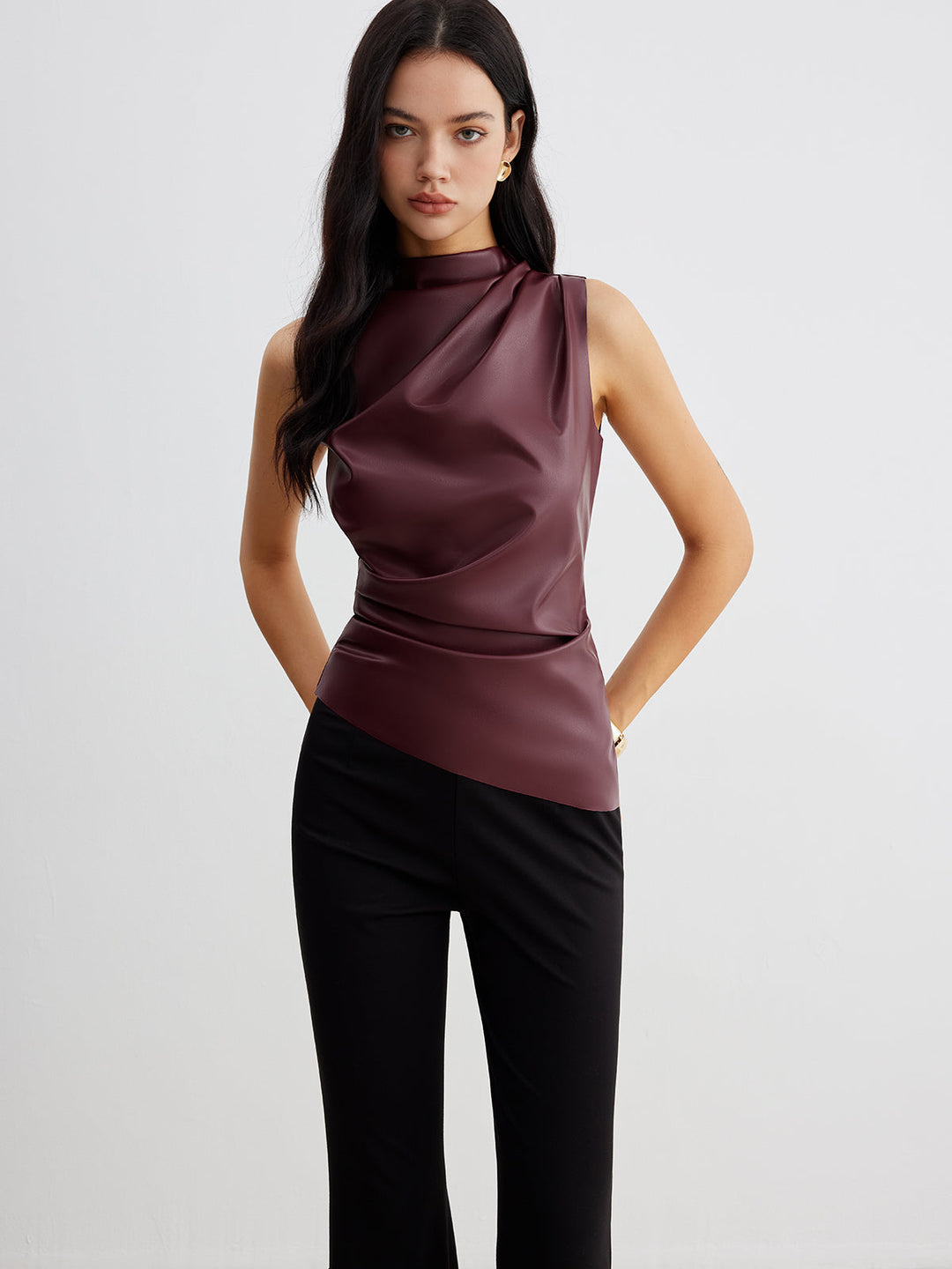 Chic women's high neck sleeveless top with a modern drape, versatile for evening or professional attire.