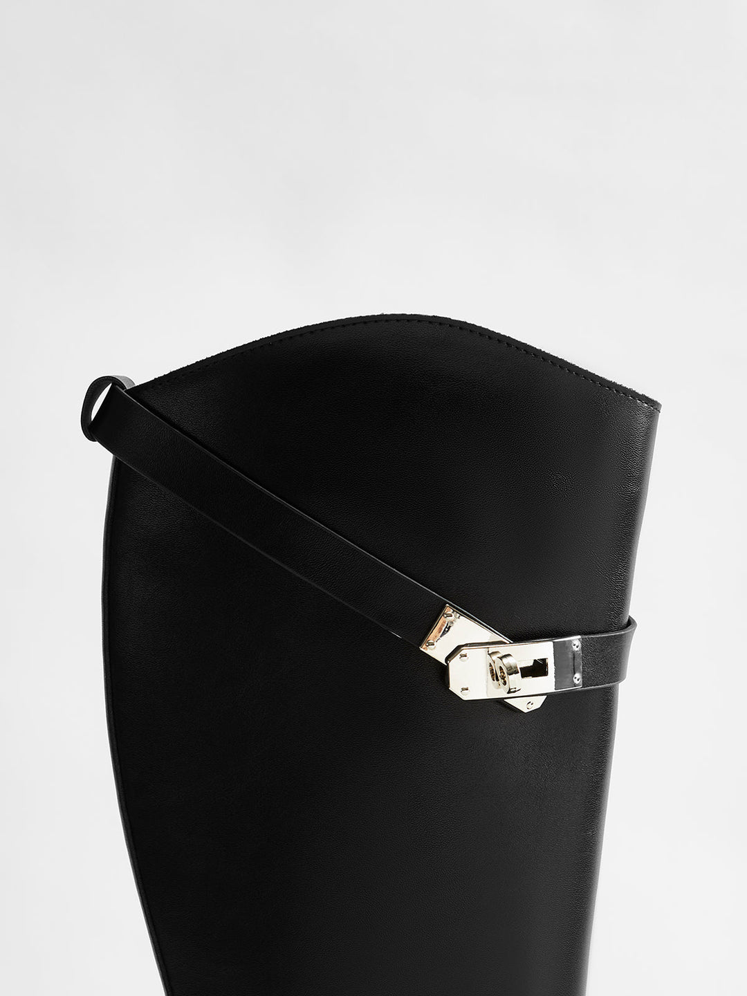 Modern women's black knee-high riding boots, round toe design, offering comfort for fall fashion.