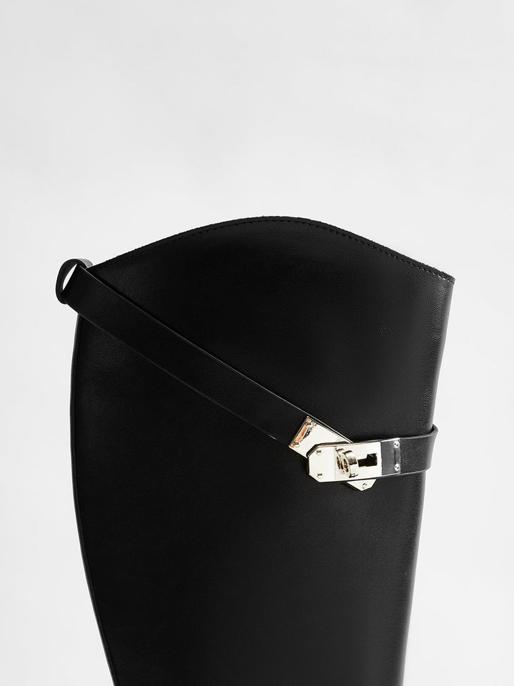 Modern women's black knee-high riding boots, round toe design, offering comfort for fall fashion.