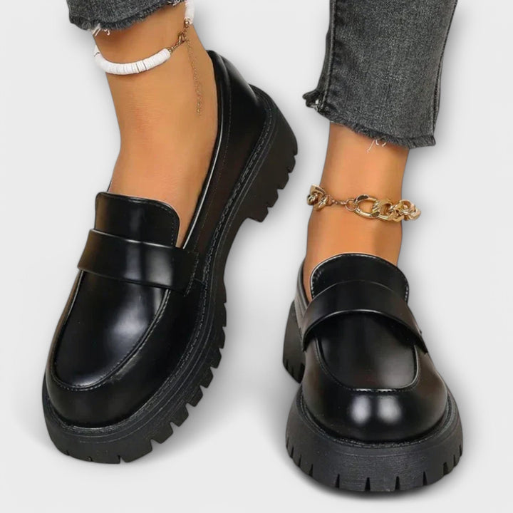 Elegant black women's loafers with orthopaedic support. Stylish slip-on flats for casual or smart wear.