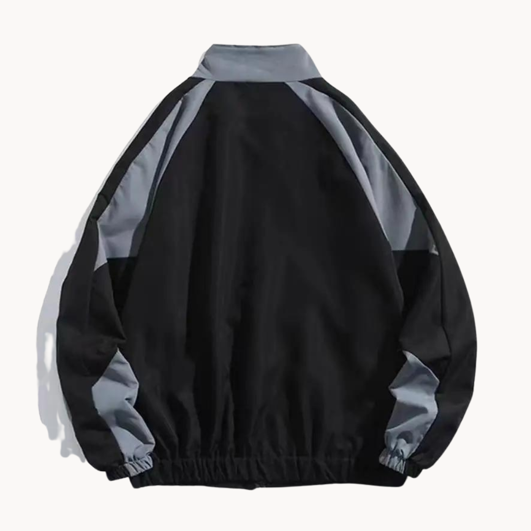 Man jogging in a dynamic Men's Meridian performance track jacket, designed for gym wear and active workouts.