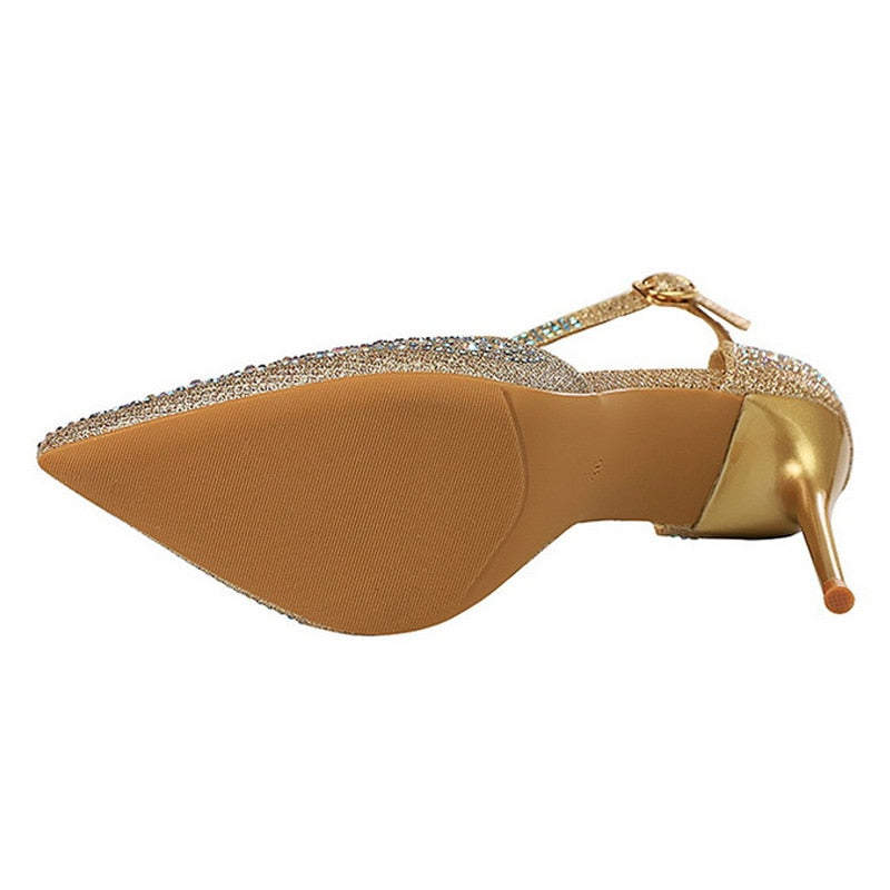 Glamorous women's stiletto sandals featuring sparkling rhinestones & a secure ankle strap for events.