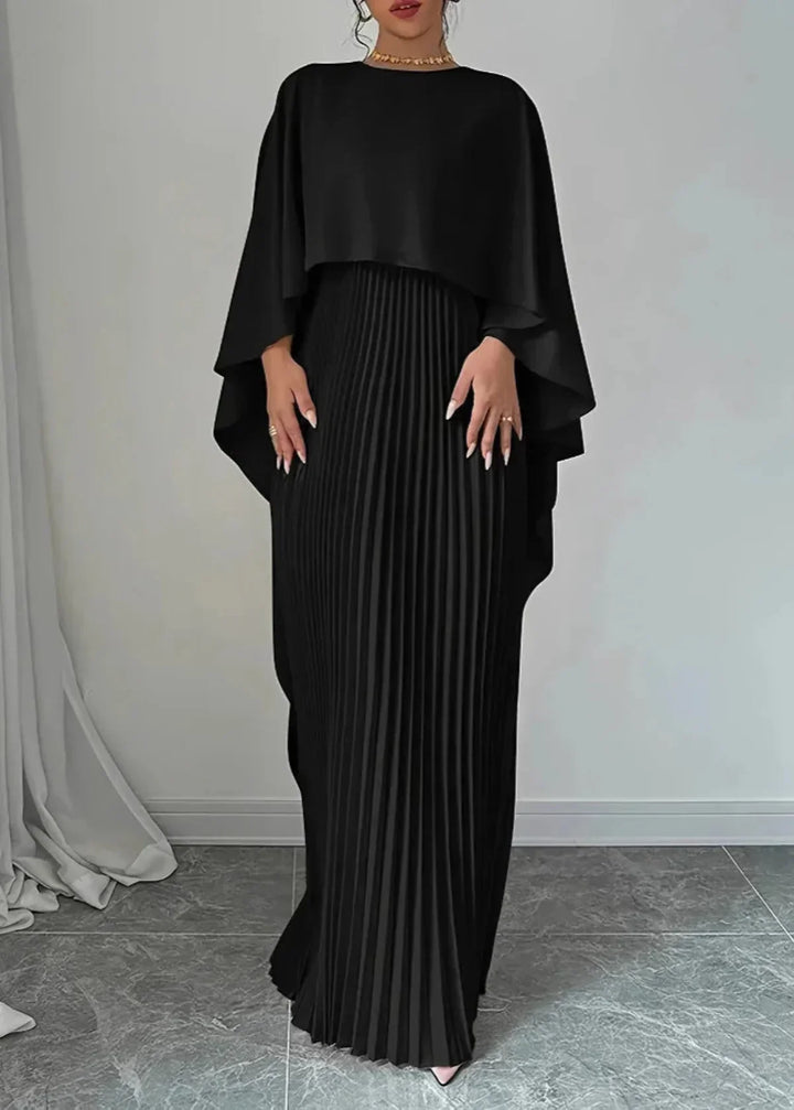 Sophisticated women's pleated maxi dress with a dramatic flowing cape, an elegant choice for evening events.