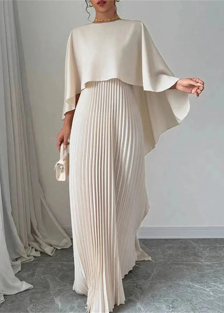 Chic women's formal gown: a modern pleated maxi dress with an elegant flowing cape, ideal for evening wear.