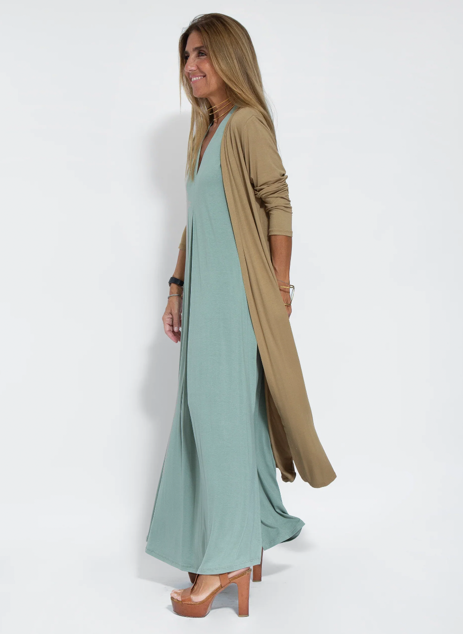 Close-up of elegant fabric on women's long slimming dress and matching vest set, stylish & comfortable.