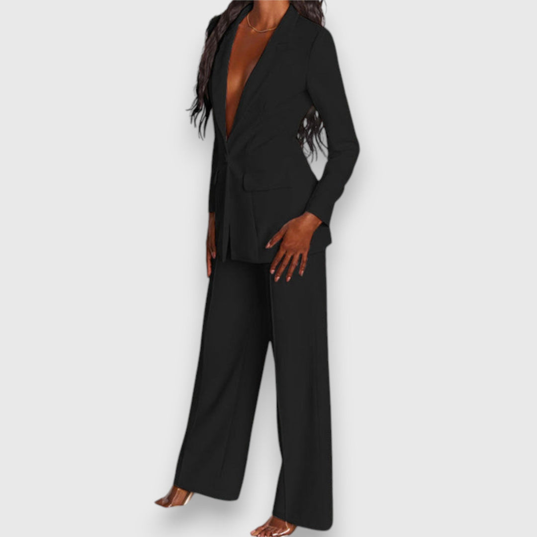 Full view of an elegant women's two-piece blazer & trousers set. Formal office & evening wear.