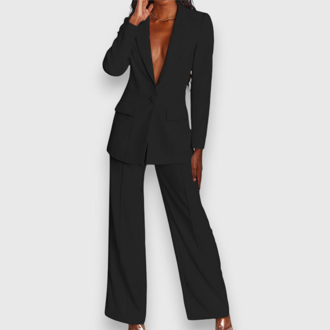 Woman wearing an elegant two-piece blazer & trousers set. Perfect formal & chic evening outfit.