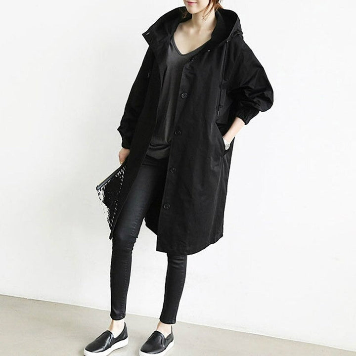 Woman in a classic waterproof trench coat. Elegant outerwear for versatile spring & fall fashion, all-weather style.