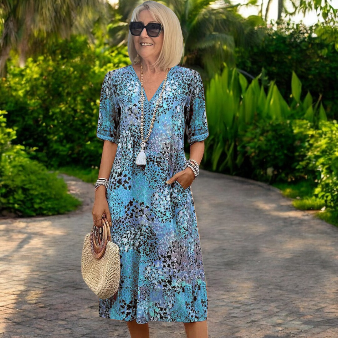Comfortable women's midi dress featuring a vibrant print and flowing silhouette, ideal for versatile summer style.