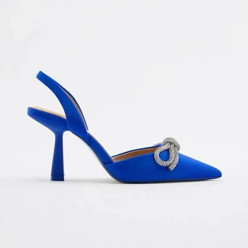 Stylish black pointed toe high heels with a chic bow, ideal women's dress or party sandals for summer.