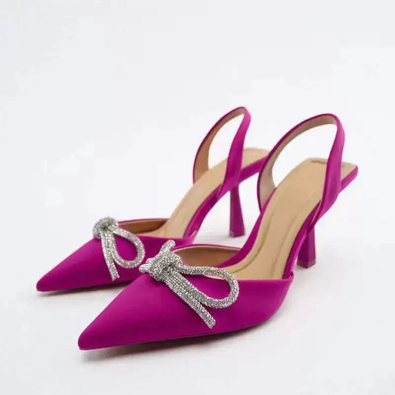 Vibrant green high heel sandals with a pointed toe and bow. Perfect elegant summer dress shoes for women.