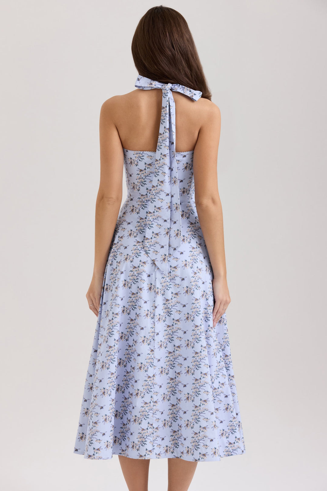 Full view of women's daisy print halter neck midi dress with button detail & A-line cut, ready for summer.