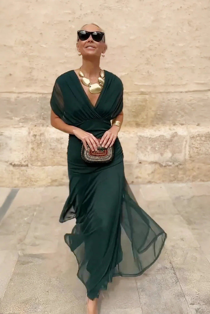 Women's long V-neck wrap dress, elegant design with sheer sleeves, ideal for spring/summer events.