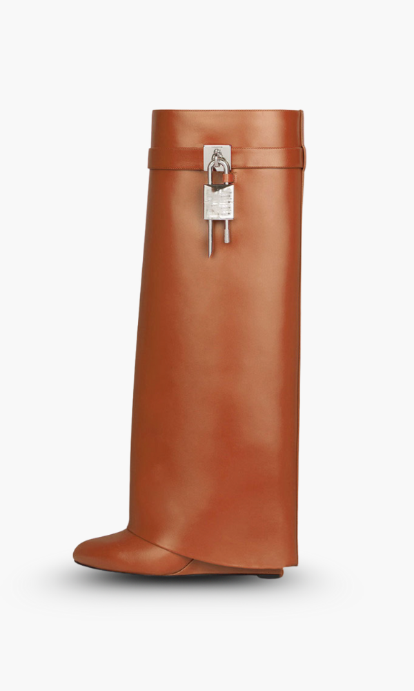 Modern women's tall boots with a glossy sheen and a sculpted wedge heel for winter fashion.