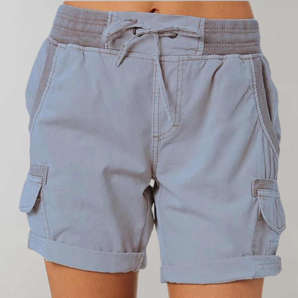 Detail of women's high waist cargo shorts featuring secure ribbed elastic waistband and functional side pockets.