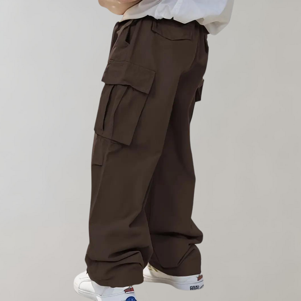 Side view: Men's oversized utility pants. Generous pockets & straight leg for streetwear.