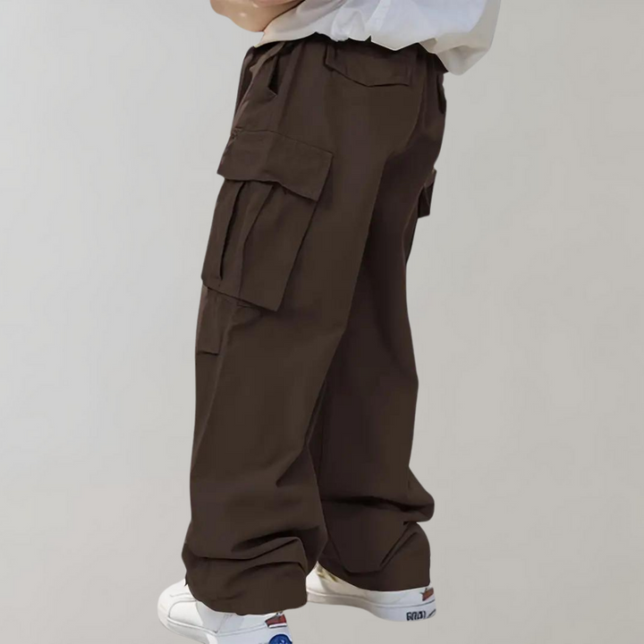 Side view: Men's oversized utility pants. Generous pockets & straight leg for streetwear.