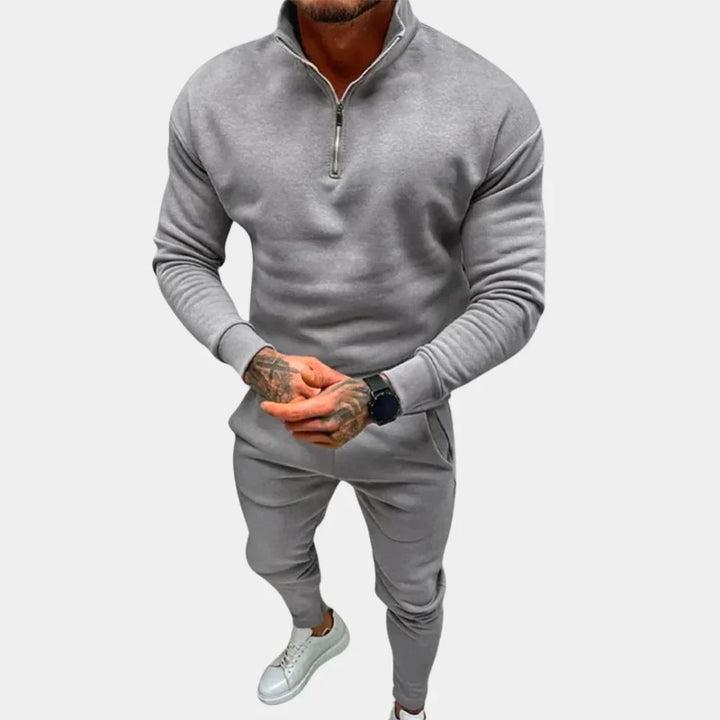 Modern men's slim-fit tracksuit featuring a comfortable hoodie and joggers, ideal for sportswear and active use.