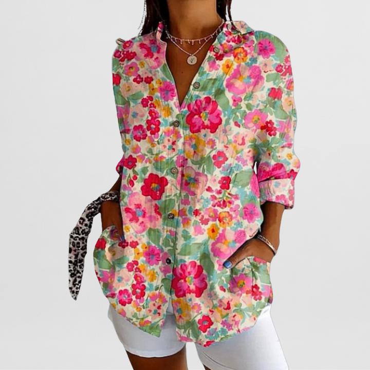 Effortless ladies' tropical floral print blouse. Loose fit, long sleeve, button front for elegant casual wear.