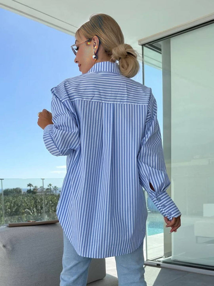 Stylish women's button-up blouse with vertical stripes, long sleeves, and a versatile, elegant design.