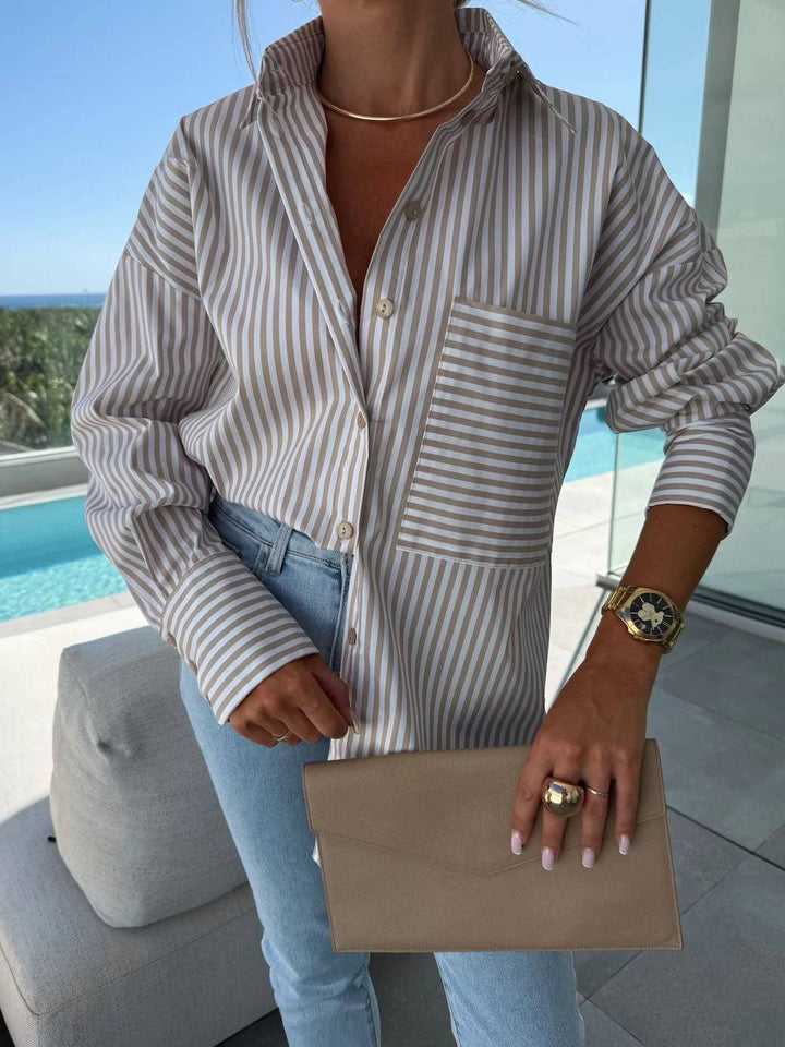 Elegant women's striped button-up shirt, a relaxed fit top with a smart collar and sophisticated look.
