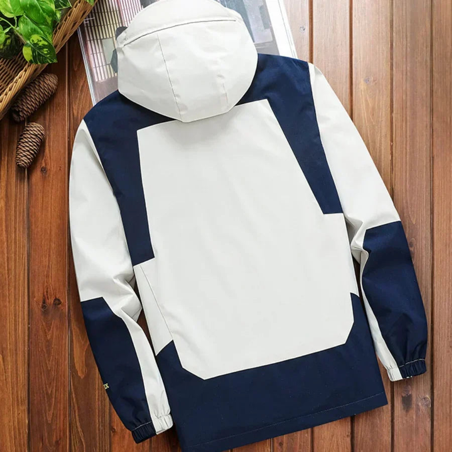 Fashionable men's hooded rain jacket. Color block design offers style & protection for transitional spring/fall weather.