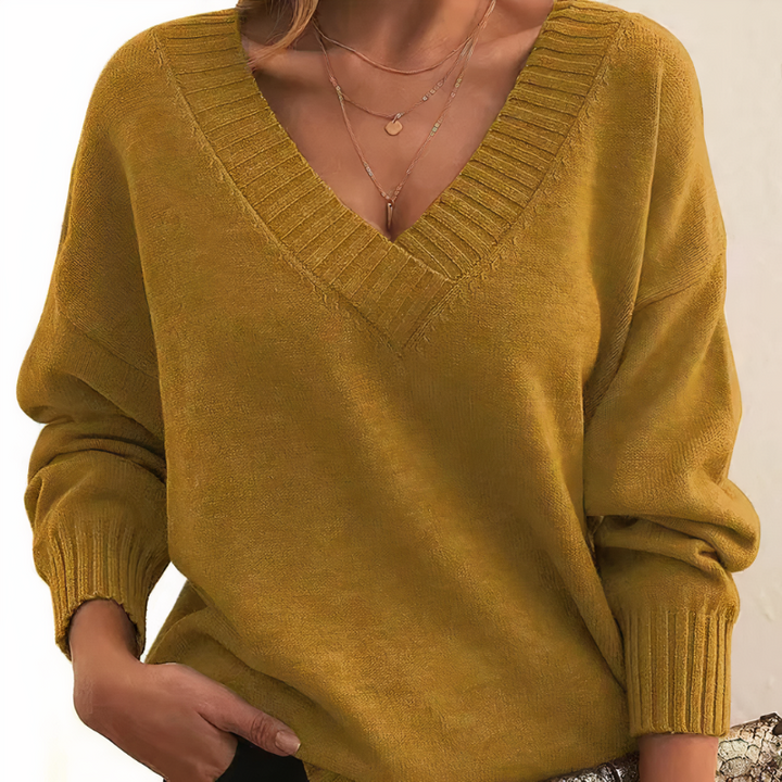 Chic women's V-neck pullover sweater, elegant knit for versatile wear. Cozy long sleeve top, perfect for fall fashion.