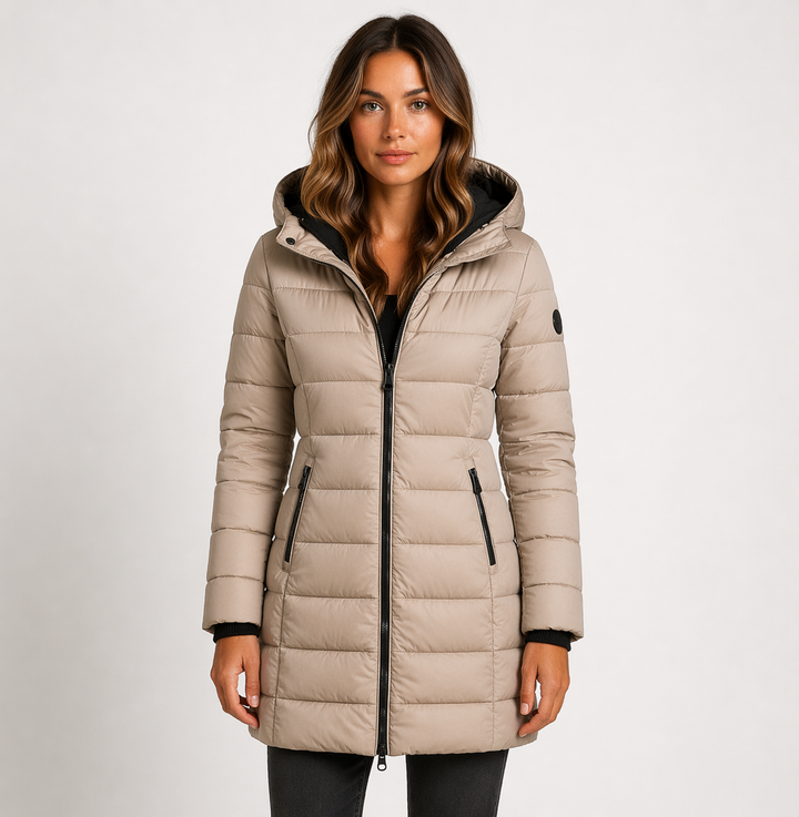 Warm women's puffer jacket with hood. Quilted, mid-thigh design ensures comfort in cold weather. Essential winter fashion.