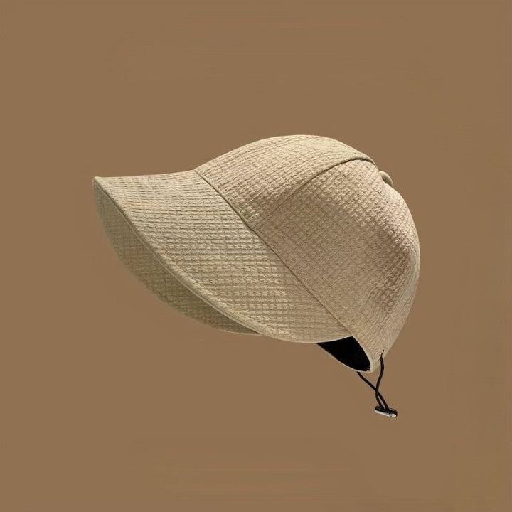 Chic women's beach sun hat, providing UPF protection. Adjustable drawstring ensures a comfortable and fashionable fit.