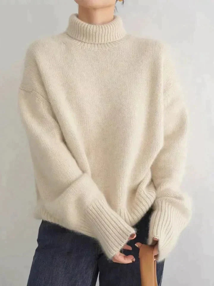 Soft white women's turtleneck sweater featuring a comfortable relaxed fit, ideal for cozy and chic winter wear.