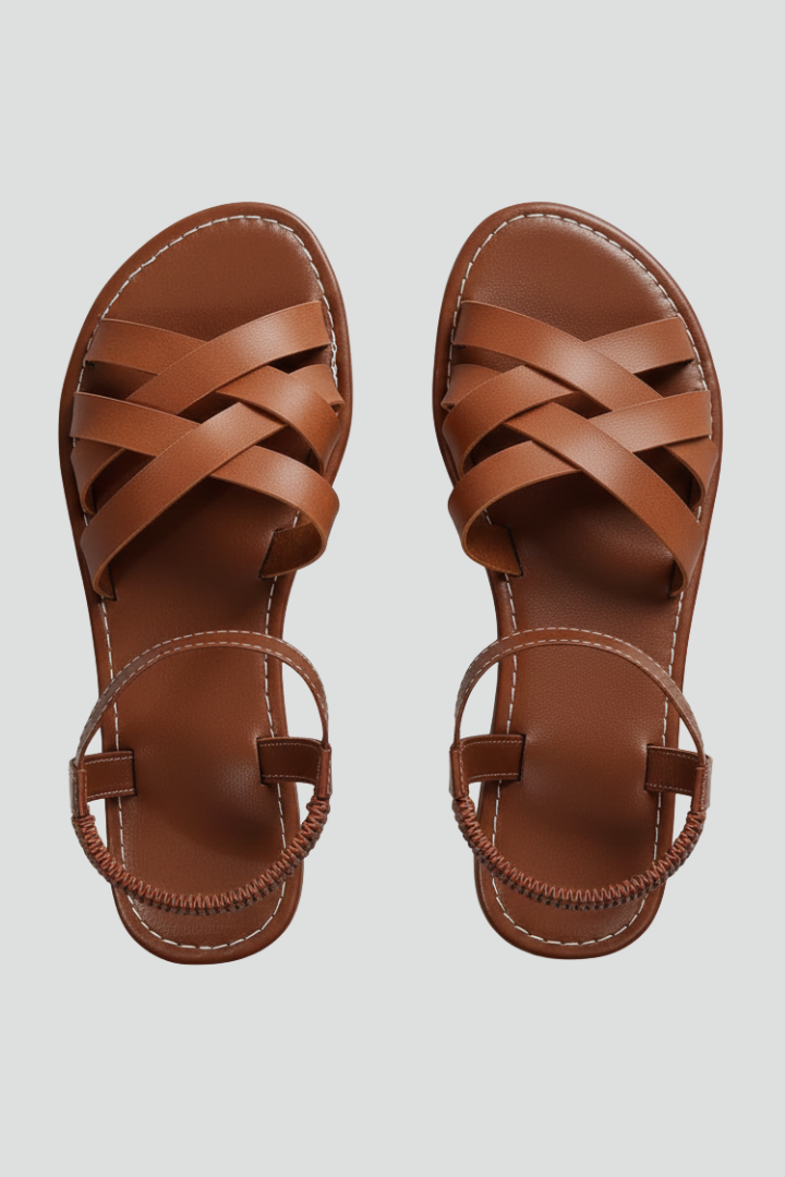 Elegant women's crisscross strap ankle sandals. Comfortable flat summer footwear for warm weather fashion.
