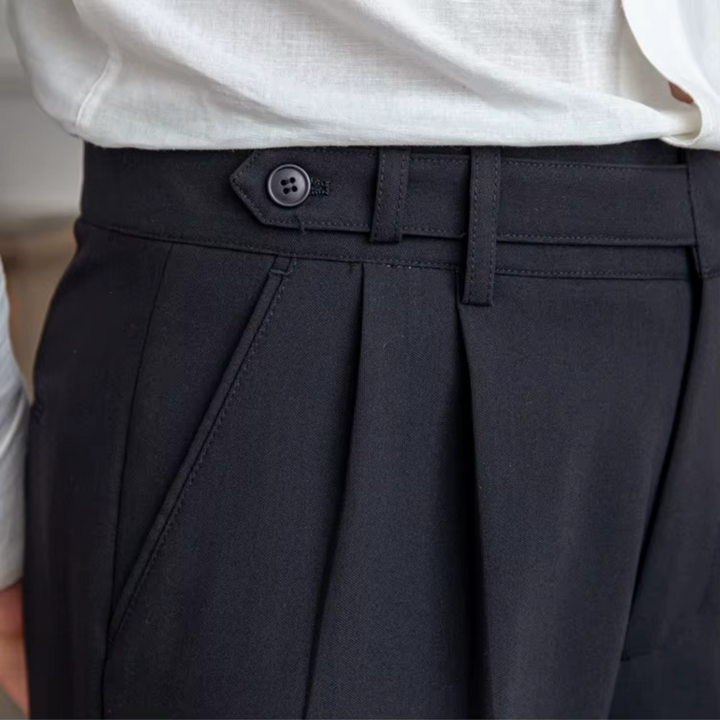 Men's elegant pleated chino trousers, a tailored and sophisticated menswear piece.