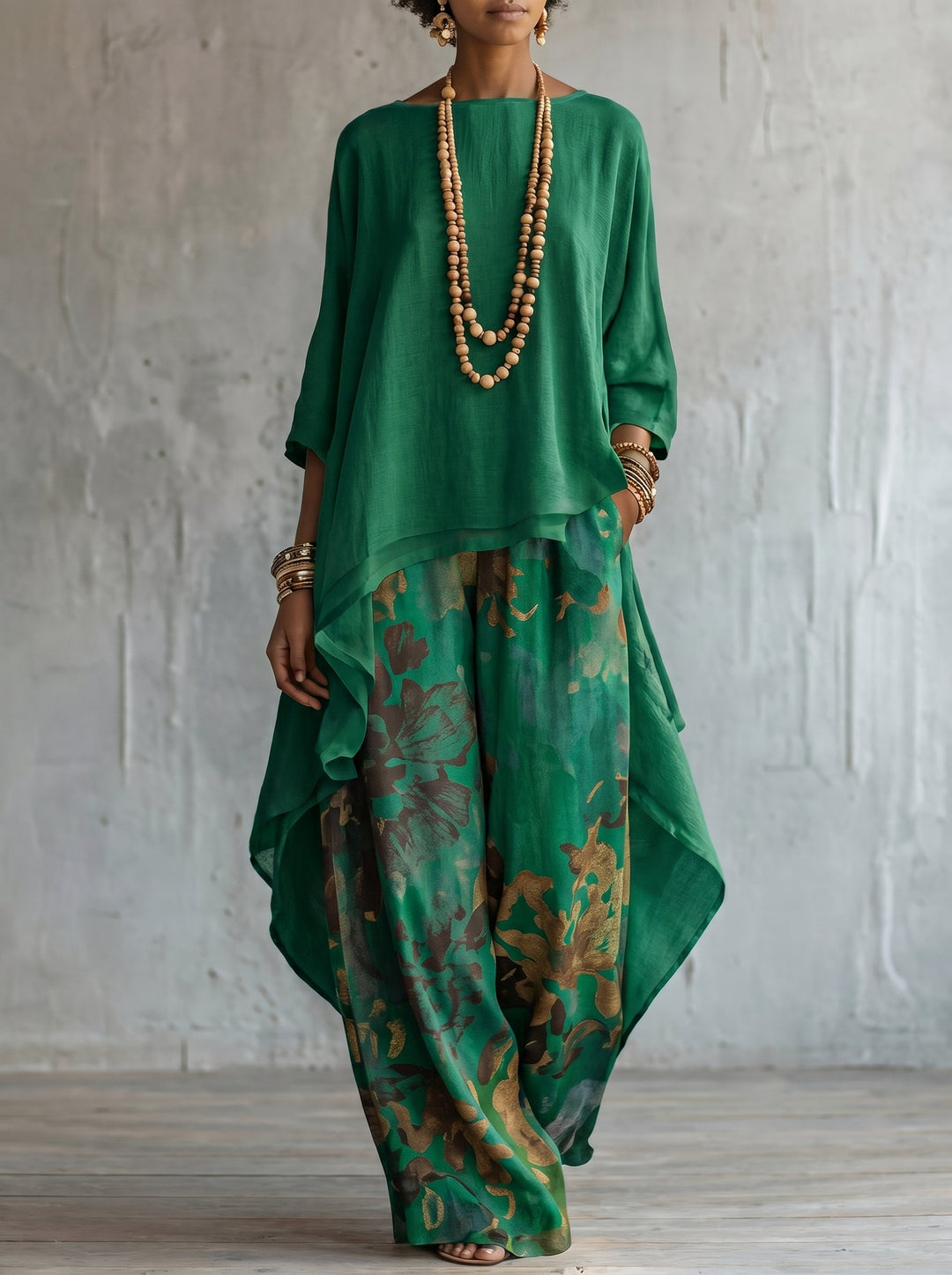 Casual chic women's two-piece floral set. Includes a flowing cape top and comfortable wide leg resort wear pants.