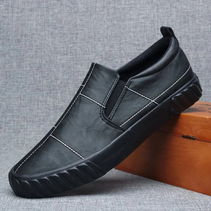 Comfortable men's slip-on loafers, ideal for casual wear, featuring distinctive contrast stitching.