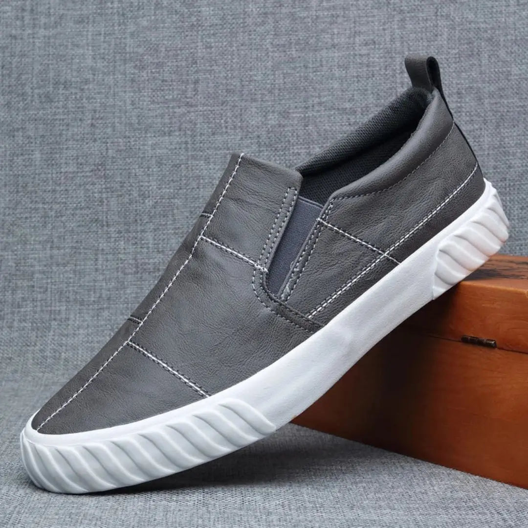 Stylish men's casual loafers, easy slip-on design with unique contrast stitching for modern footwear.