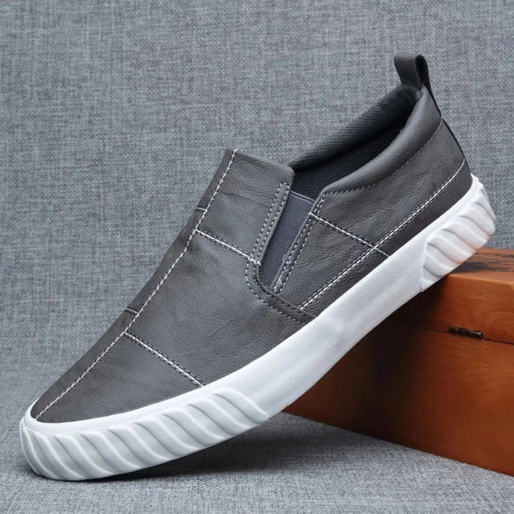 Stylish men's casual loafers, easy slip-on design with unique contrast stitching for modern footwear.