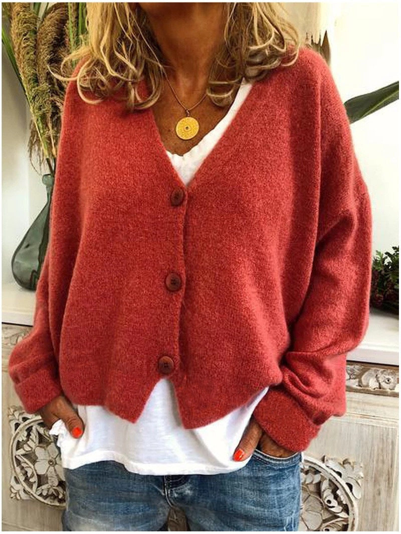 Detail of the button-front and V-neck on a women's chic knitwear cardigan.