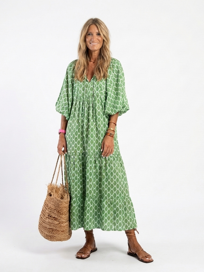 Women's patterned midi dress with V-neck & 3/4 sleeves. Flowy, comfortable, and elegant for spring/summer.