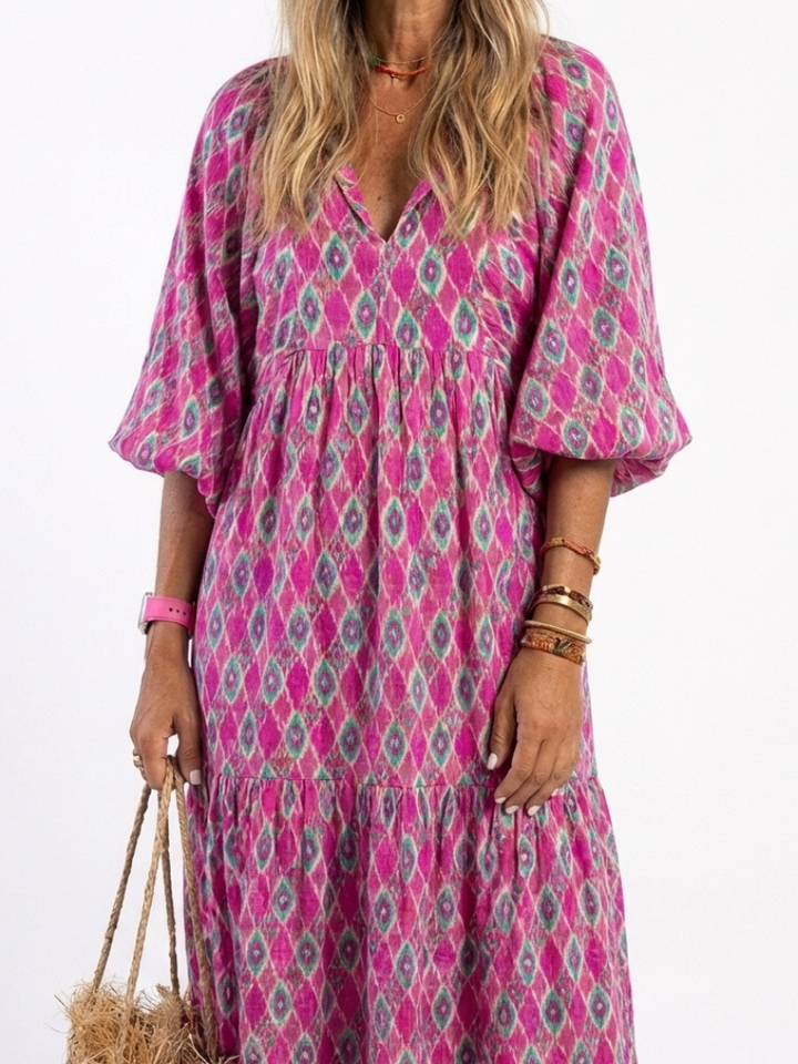 Women's patterned V-neck midi dress with 3/4 sleeves, showcasing its comfortable, flowy, and versatile design.