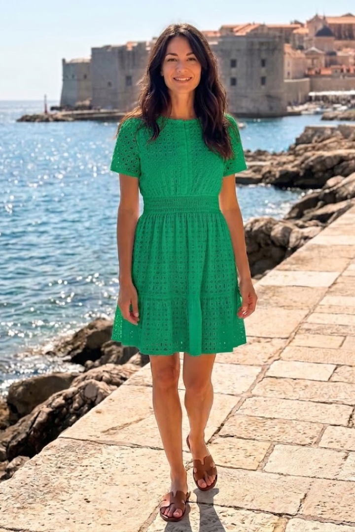 Comfortable women's eyelet mini dress with playful flutter sleeves, a short casual design for summer wear.