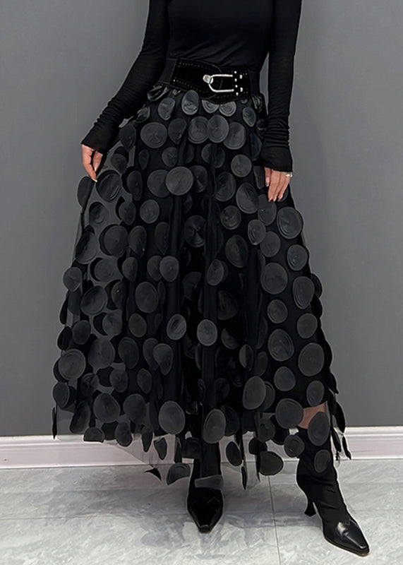 Detailed view of the unique patchwork design on a chic women's polka dot maxi skirt.