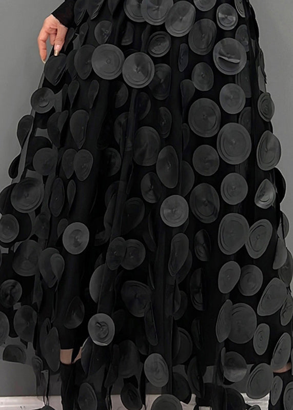 Flowing fabric of a women's elegant polka dot patchwork long skirt, ideal for chic party wear.