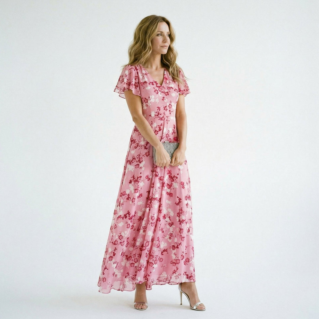 Women's flowy maxi dress with vibrant floral print and V-neck, ideal for elegant wedding guests.