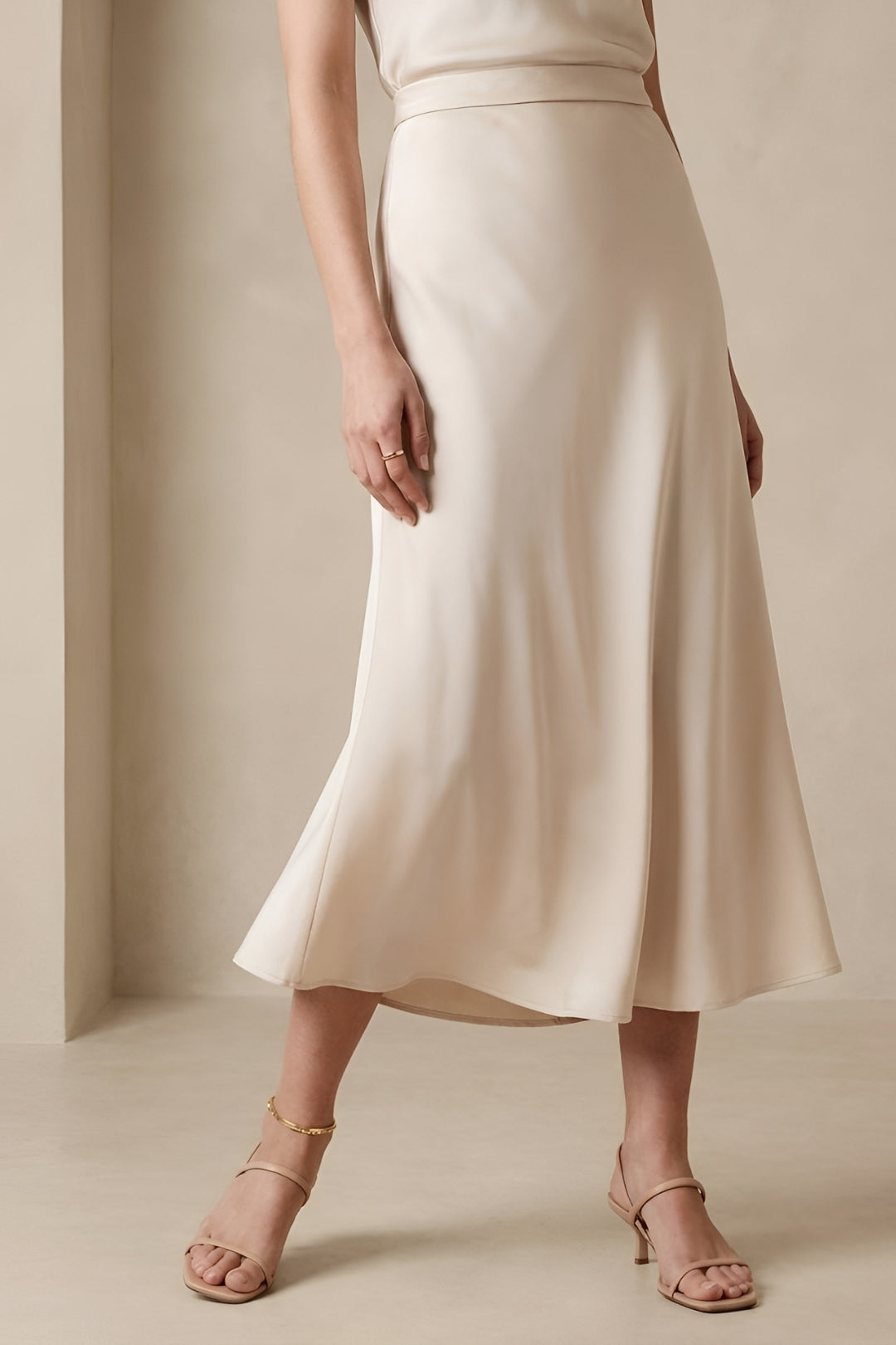 Chic women's high-waisted A-line midi skirt. A versatile and elegant flared design for spring and summer fashion.