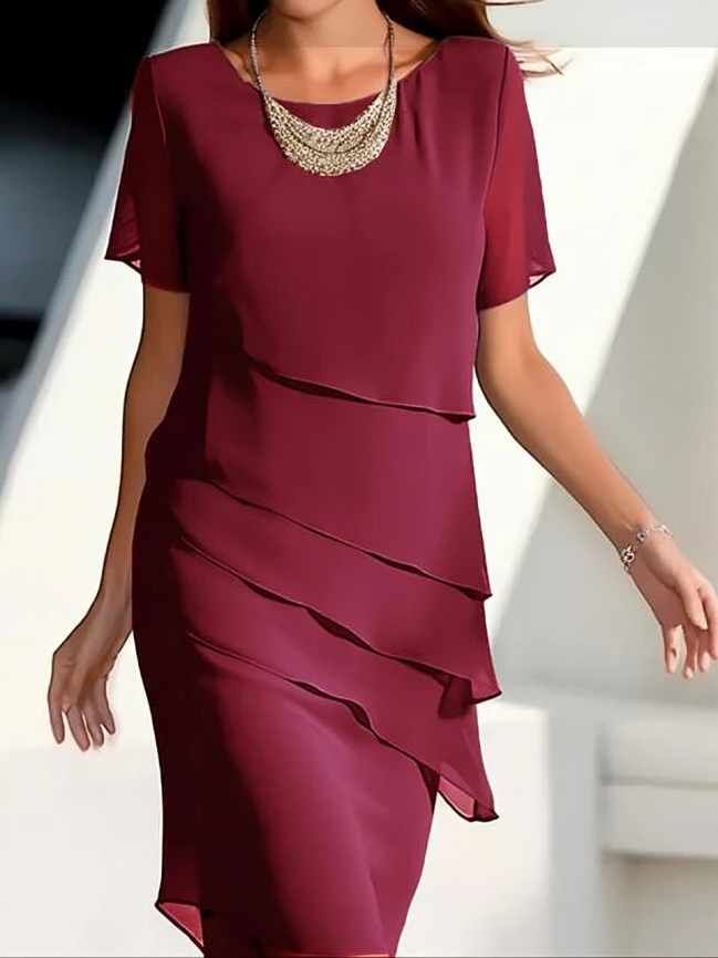 Stylish women's layered midi dress with short sleeves. Elegant design makes it ideal for sophisticated occasion wear.
