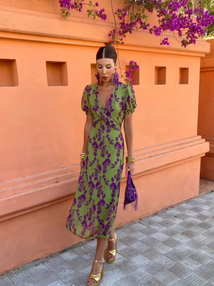 Flowy women's summer maxi dress in a vibrant floral print, styled with a chic wrap V-neck. Perfect for warm weather.