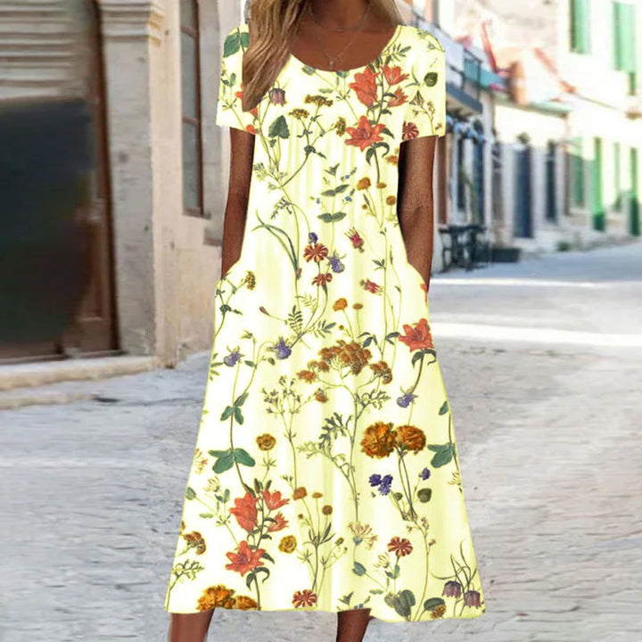 Stylish Amarae women's long floral bohemian dress, ideal for spring or summer, with short sleeves and convenient pockets.