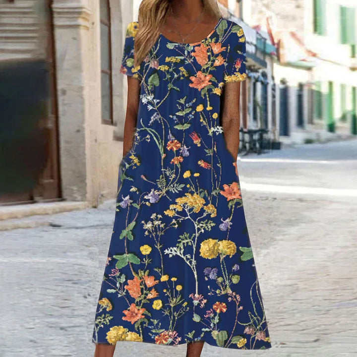 Elegant Amarae women's floral print long dress with short sleeves, a flowing bohemian design and functional pockets.