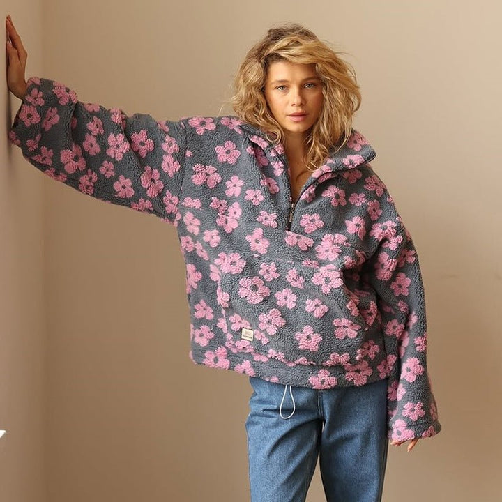 Woman wearing a cozy oversized floral half-zip sweater jacket, showcasing casual fall fashion.