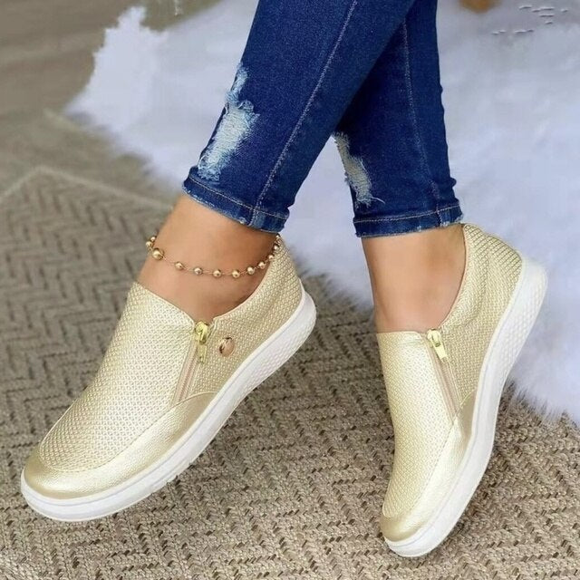 Black women's platform slip-on sneakers with stylish side zip, versatile for fashion & comfort.